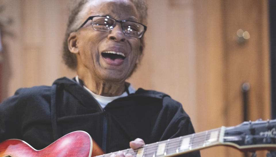 Portrait shot of blues player George Freeman playing an electric guitar