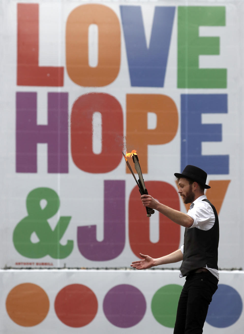 A joggler entertains tourists and visitors at Covent Garden in London, Friday, Oct. 30, 2020. (AP Photo/Frank Augstein)