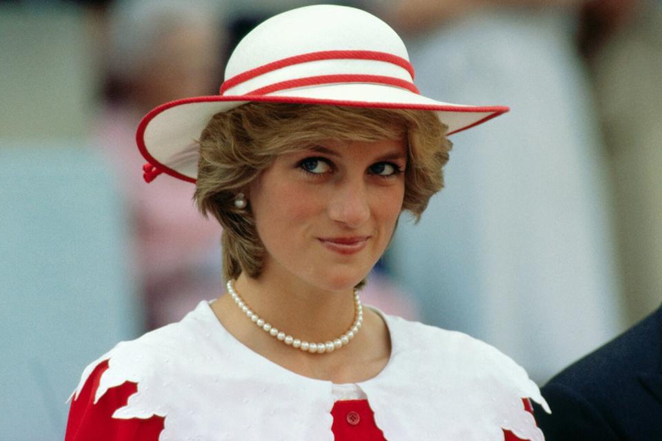 Diana, Princess of Wales, wears an outfit in the colors of Canada during a state visit to Edmonton, Alberta, with her husband.