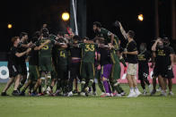 Portland Timbers players celebrate after defeating Orlando City 2-1, during an MLS soccer tournament, Tuesday, Aug. 11, 2020, in Kissimmee, Fla. (AP Photo/John Raoux)