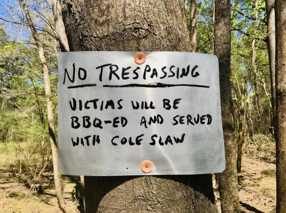 A no trespassing sign on the banks of Singleton Creek, a part of Bates Old River near Congaree National Park, mixes a bit of Southern humor with its statement of property rights.
