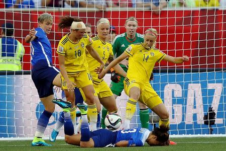 Jun 12, 2015; Winnipeg, Manitoba, CAN; Sweden defender Amanda Ilestedt (14) looks to clear the loose header by United States midfielder Carli Lloyd (front) during the second half in a Group D soccer match in the 2015 FIFA women's World Cup at Winnipeg Stadium. The game ended in a draw 0-0. Mandatory Credit: Bruce Fedyck-USA TODAY Sports