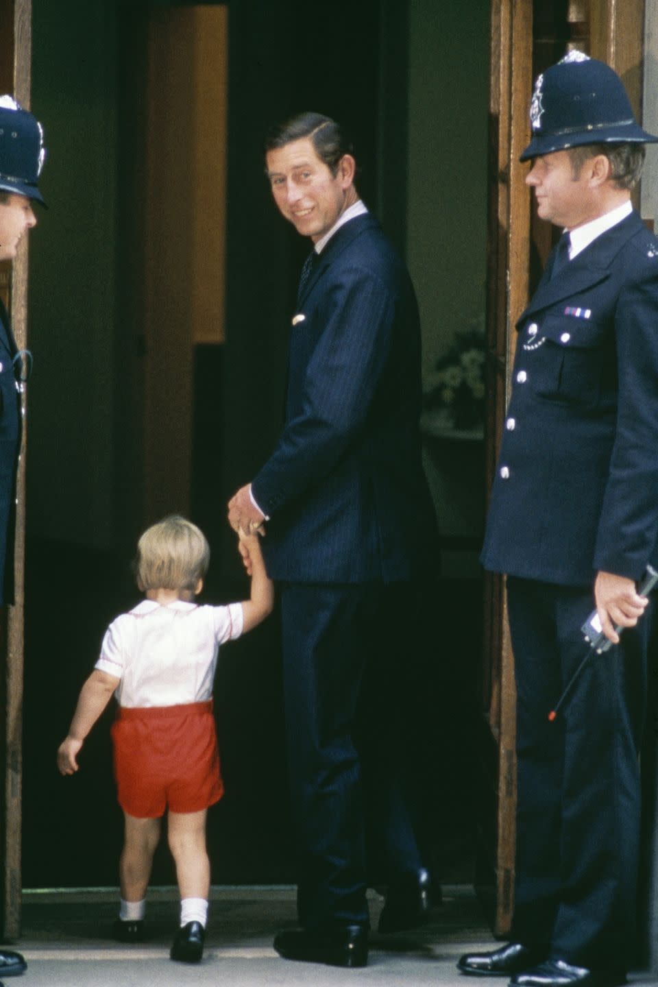 <p>Charles holds William's hand as they arrive at St Mary's Hospital to visit Princess Diana and newborn Prince Harry. </p>