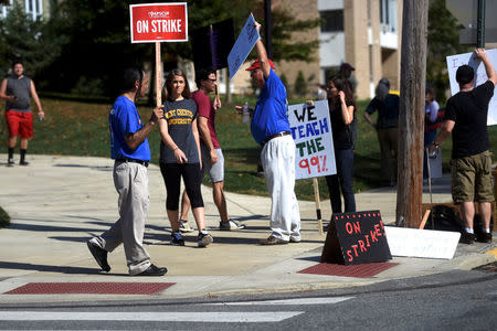 West Chester University students demonstrate with university employees from the union representing 5,500 Pennsylvania university and college employees after failing to reach a contract deal with the state education system in West Chester, Pennsylvania, U.S., October 19, 2016. REUTERS/Mark Makela