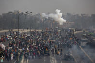 Indian police fire tear gas shells towards protesting farmer as they march to the capital breaking police barricades during India's Republic Day celebrations in New Delhi, India, Tuesday, Jan.26, 2021. Tens of thousands of farmers drove a convoy of tractors into the Indian capital as the nation celebrated Republic Day on Tuesday in the backdrop of agricultural protests that have grown into a rebellion and rattled the government. (AP Photo/Altaf Qadri)