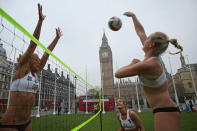 LONDON, ENGLAND - MAY 24: Members of Great Britain women's Beach Volleyball team (L-R) Lucy Bolton, Zara Dempney and Shauna Mullin take part in a 'Stop Traffic' photocall on Parliament Square on May 24, 2012 in London, England. The PR stunt was aimed at reminding commuters that roads were likely to be busier at peak times during the 2012 London Olympic Games. (Photo by Dan Kitwood/Getty Images)