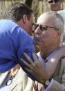 Britain's then-opposition Conservative Party leader David Cameron, embraces his father Ian, before addressing supporters in the garden of a pub in Swindon, south west England April 18, 2010. REUTERS/Toby Melville