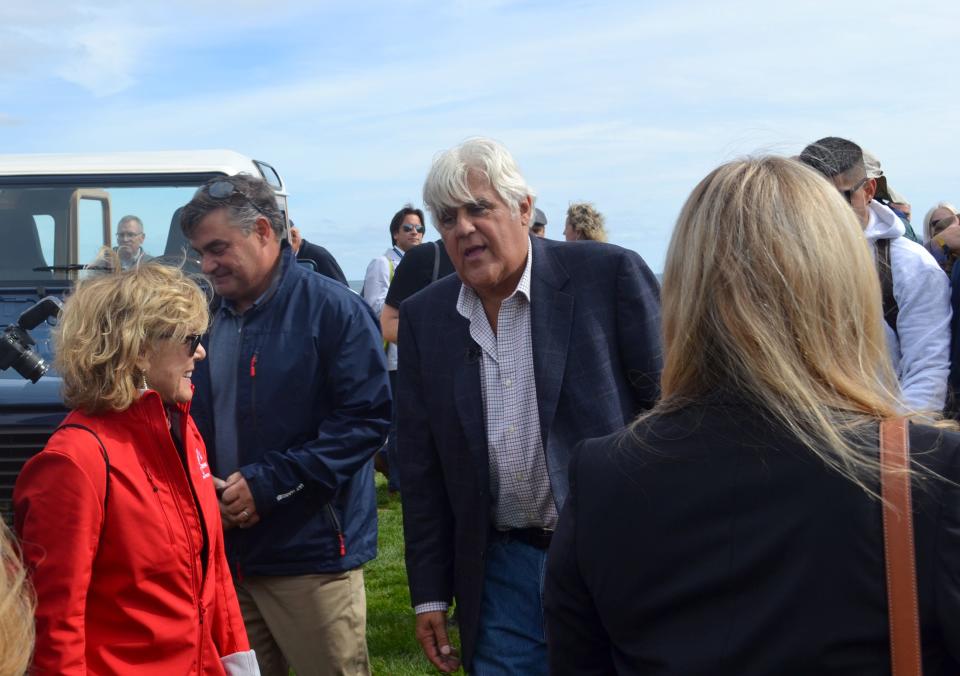 Jay Leno chats with fellow car enthusiasts Friday during The Gathering at Rough Point in Newport, part of the Audrain Concours + Motor Week.