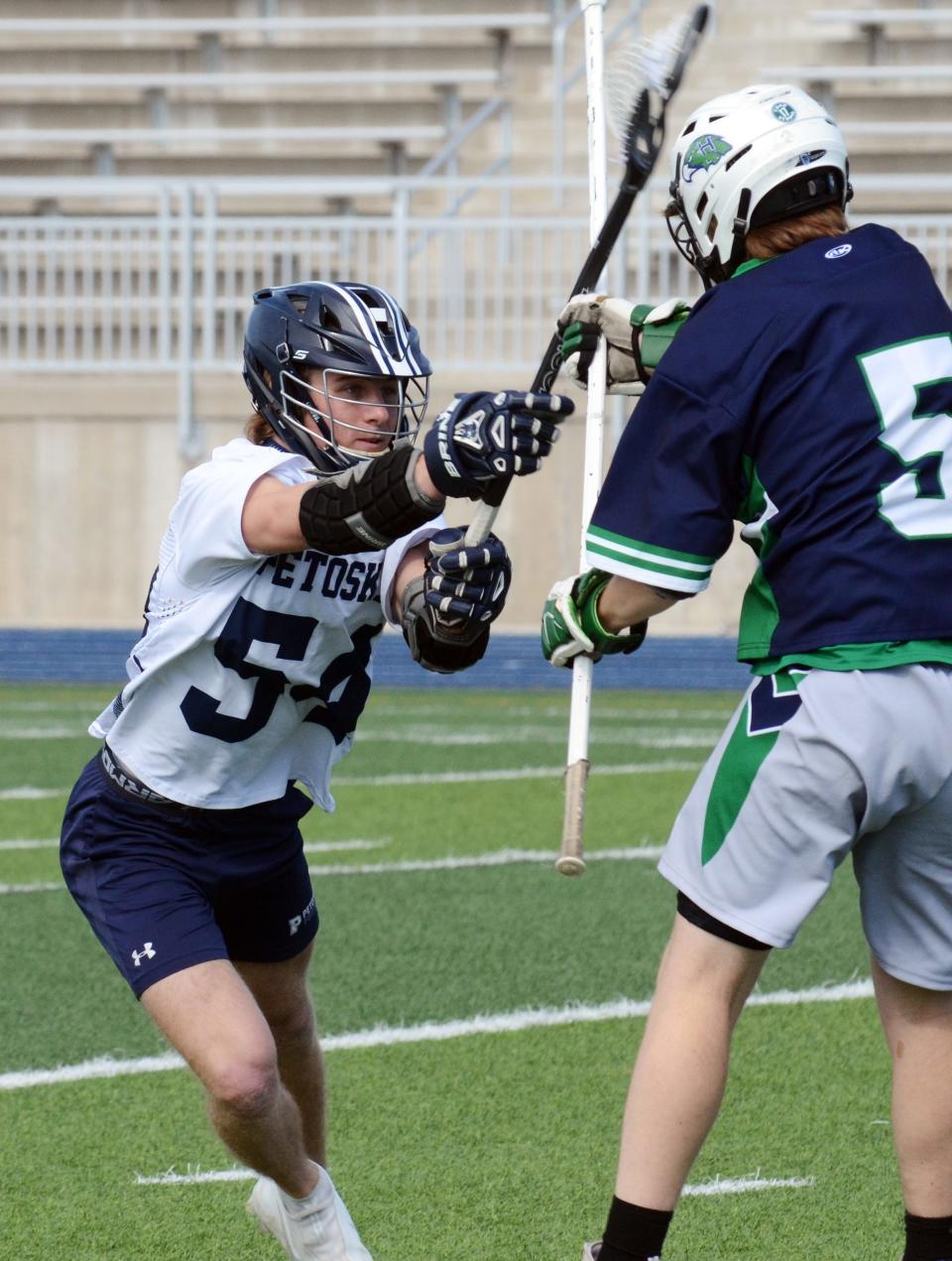 Petoskey's Caleb Gosciak defends against a Saginaw Heritage player trying to make a pass.