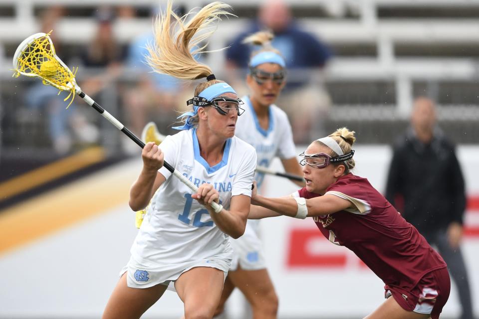 May 28, 2021; Towson, Maryland, USA;   Ally Mastroianni #12 of the North Carolina tries to get around Belle Smith #5 of the Boston College in the first half during a semi final NCAA Women’s Lacrosse Championship at Johnny Unitas Stadium. Mandatory Credit: Mitchell Layton-USA TODAY Sports