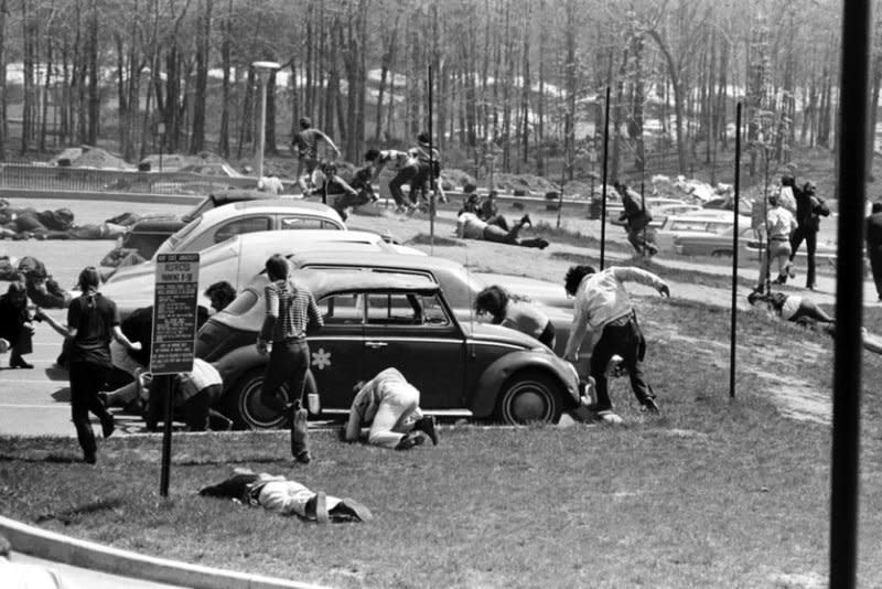 Students dive to the ground as the National Guard fires on faculty and students May 4, 1970, to protest the war in Vietnam. File Photo courtesy of Kent State University Archives