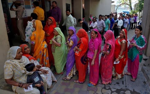 People lining up to vote in Ahmedabad on Tuesday, once the scene of riots - Credit: REUTERS/Amit Dave