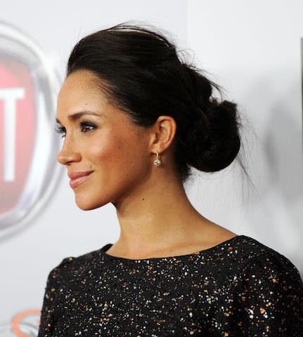 <p>At the 2013 Golden Globe Awards, Meghan switched up her style and gave her now-famous bun a swept-back makeover. (Photo: Getty Images) </p>