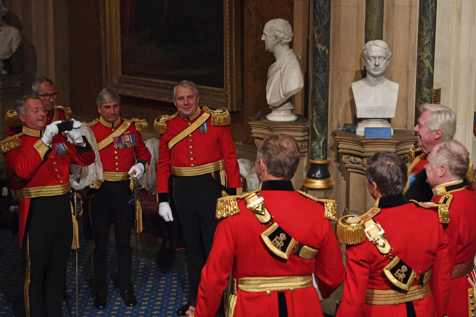 Gentlemen at Arms pose for a photograph at the Norman Porch stairs ahead of the official State Opening of Parliament in London, Monday Oct. 14, 2019. (Paul Ellis/Pool via AP)