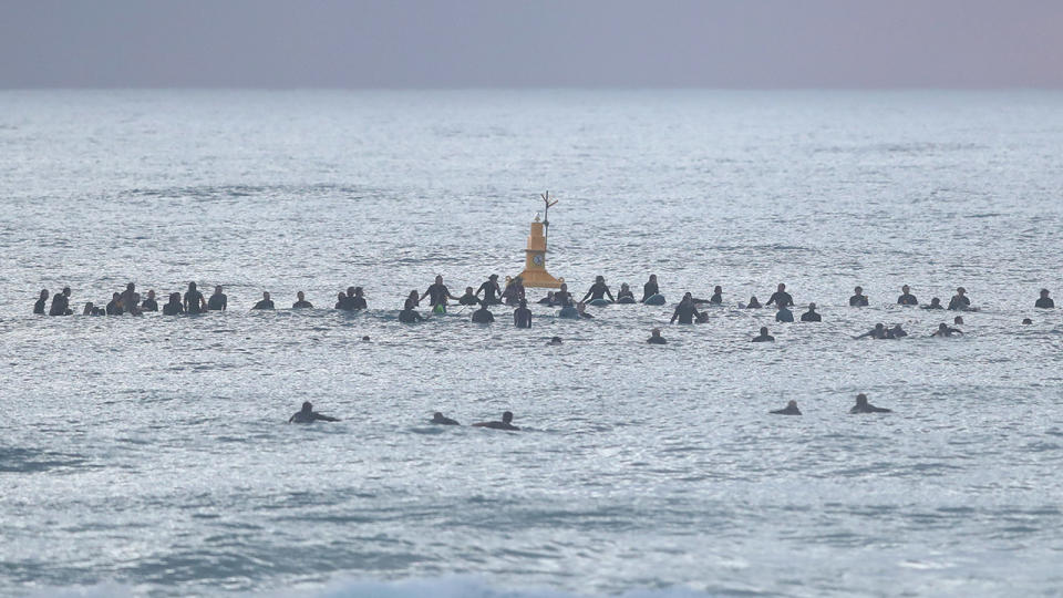 Surfers, pictured here paddling out in memory of Alex 'Chumpy' Pullin at Palm Beach.