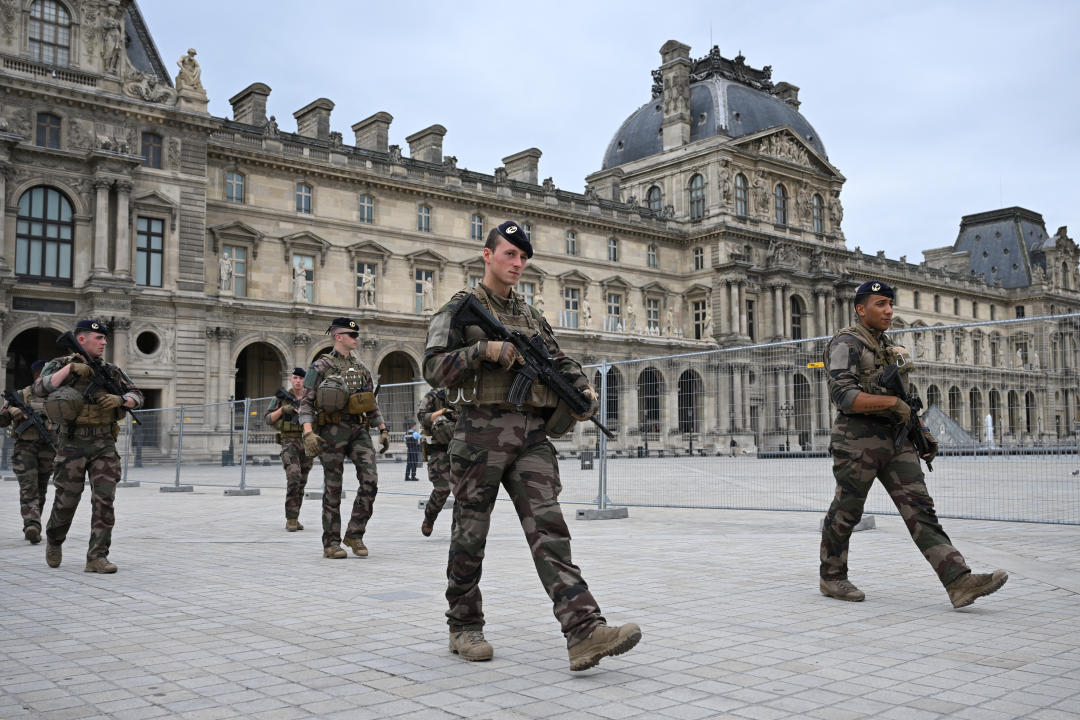 French soldiers from the Operation Sentinelle patrol at the Louvre Museum hours prior to the start of the opening ceremony of the Paris 2024 Olympic Games in Paris on July 26, 2024. (Photo by JUNG Yeon-je / AFP) (Photo by JUNG YEON-JE/AFP via Getty Images)