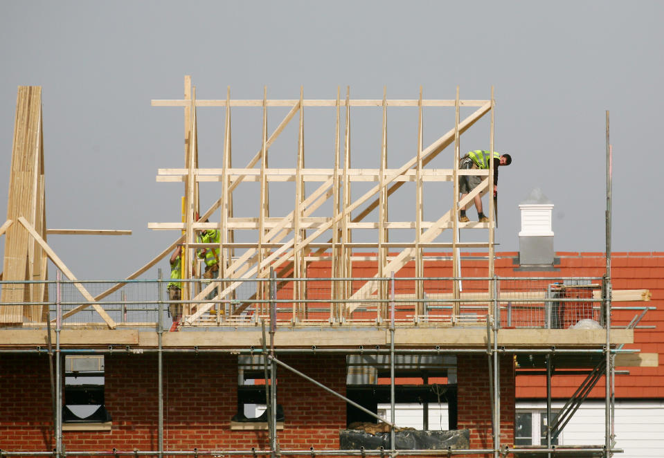 Builders at work on new homes being built around Ashford in Kent.