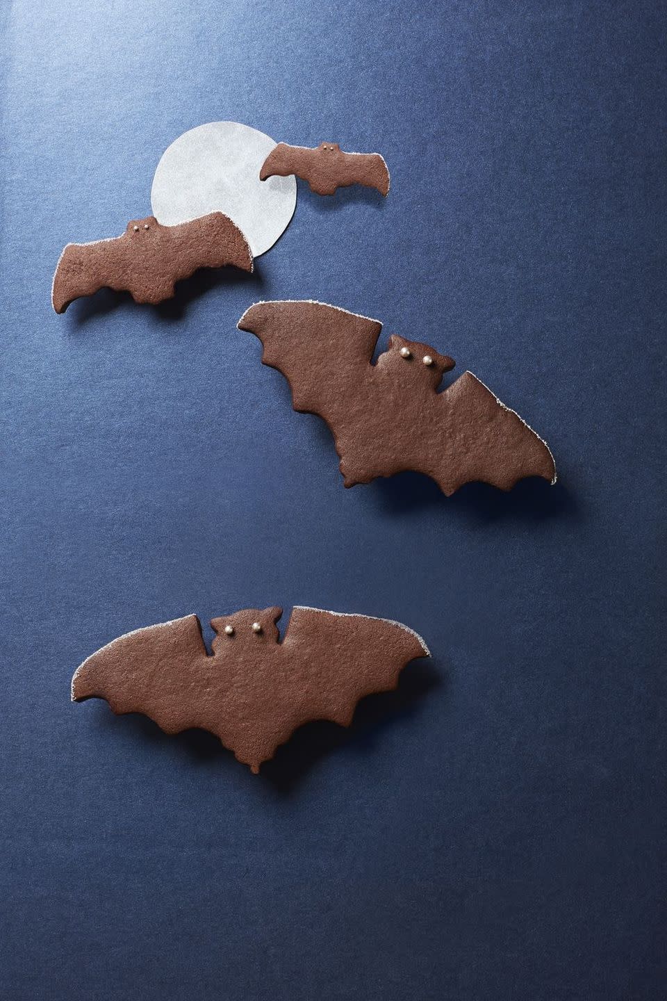 <p>These spiced chocolate bat cookies are decorated with silver edible sugar pearls. </p><p><strong><em><a href="https://www.womansday.com/food-recipes/food-drinks/recipes/a40295/spiced-chocolate-bat-cookies-recipe-clx1014/" rel="nofollow noopener" target="_blank" data-ylk="slk:Get the Spiced Chocolate Bat Cookies recipe.;elm:context_link;itc:0;sec:content-canvas" class="link ">Get the Spiced Chocolate Bat Cookies recipe. </a></em></strong> </p>