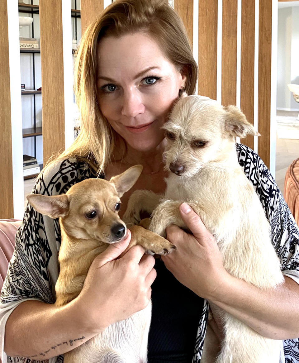 Jennie Garth cuddles two of her dogs. (Courtesy of Jennie Garth)