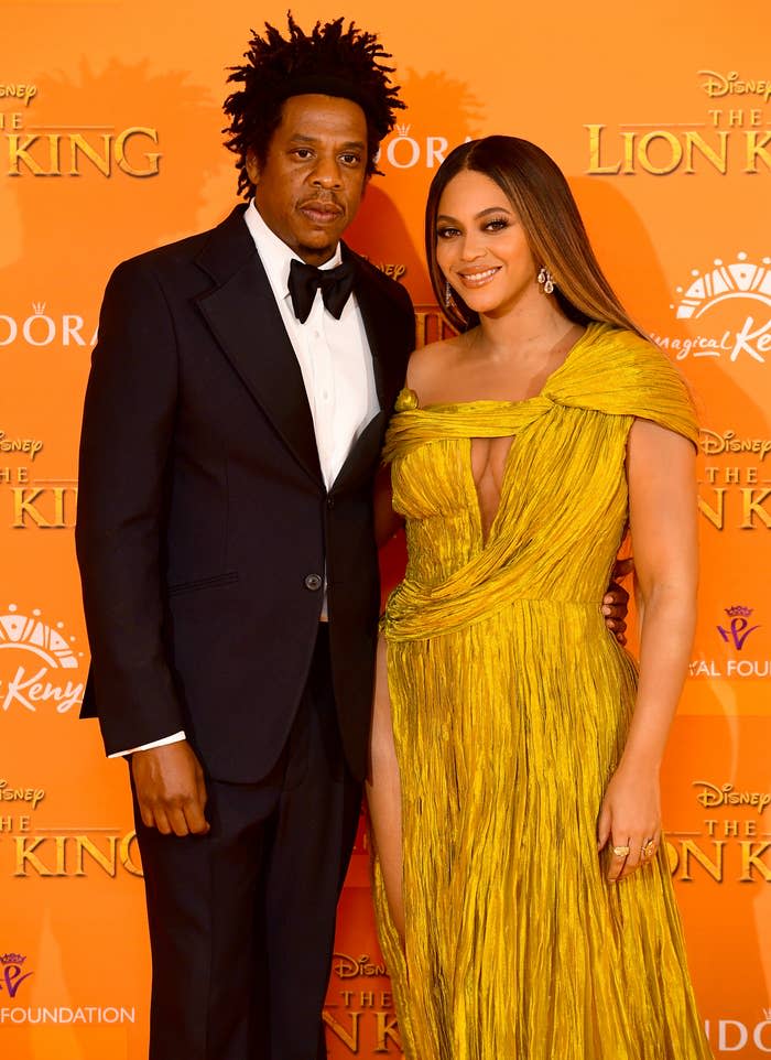 Beyoncé poses with Jay-Z in a classic suit and an elegant one-shoulder draped gown