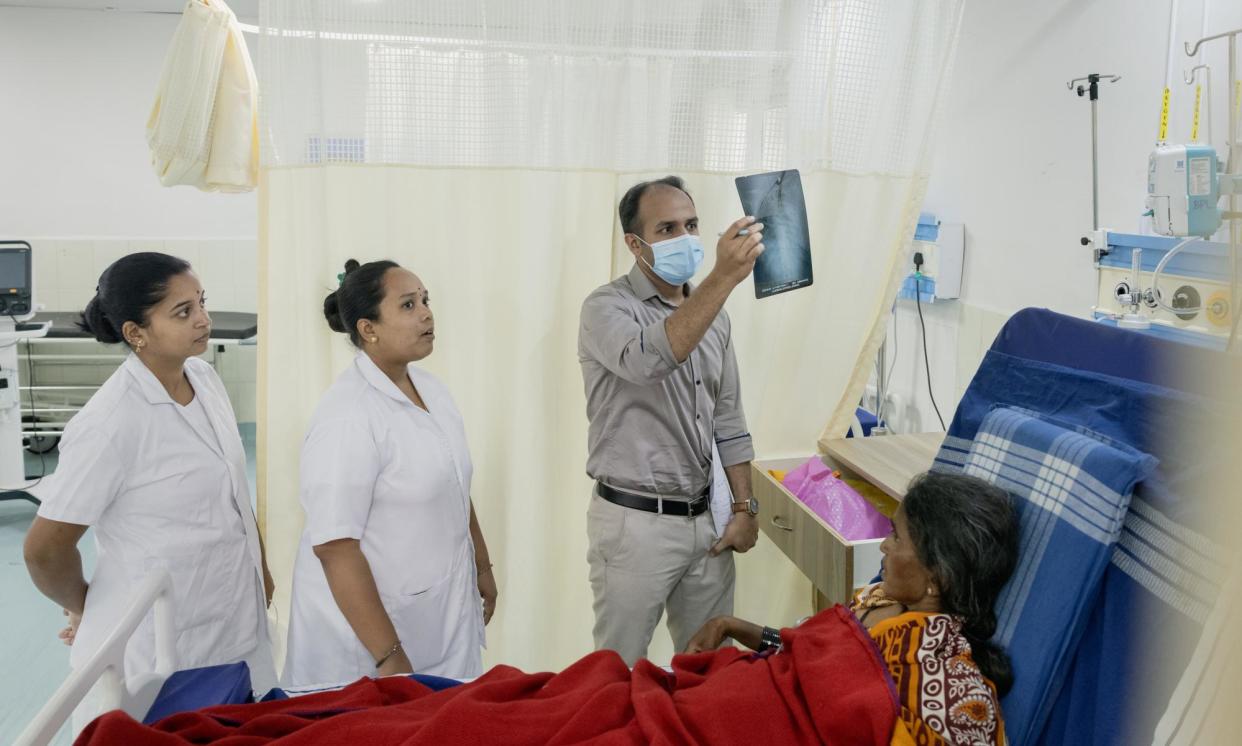 <span>Dr V Yatheendra, a surgeon at Taluk hospital in Bagepalli, checks on a patient. He can now consult specialists remotely at the tele-ICU hub</span><span>Photograph: Elke Scholiers/The Guardian</span>