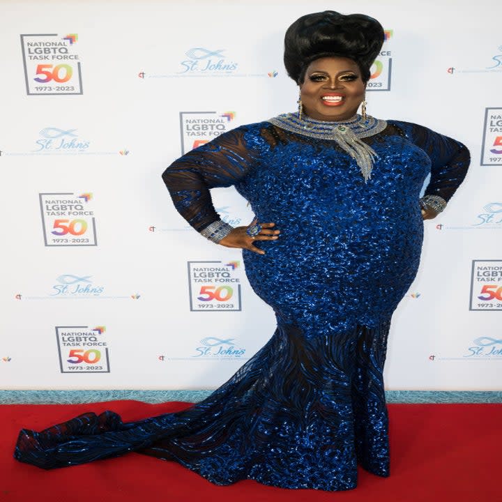 latrice on the red carpet in a gown with a train