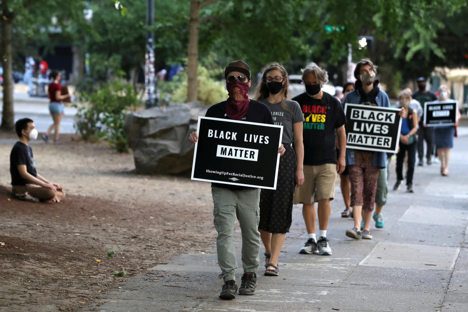 People participate in a meditation walk in support of Black Lives Matter organized by the Portland Buddhist Peace Fellowship near the Justice Center in Portland, Oregon, U.S., September 1, 2020. REUTERS/Caitlin Ochs     TPX IMAGES OF THE DAY