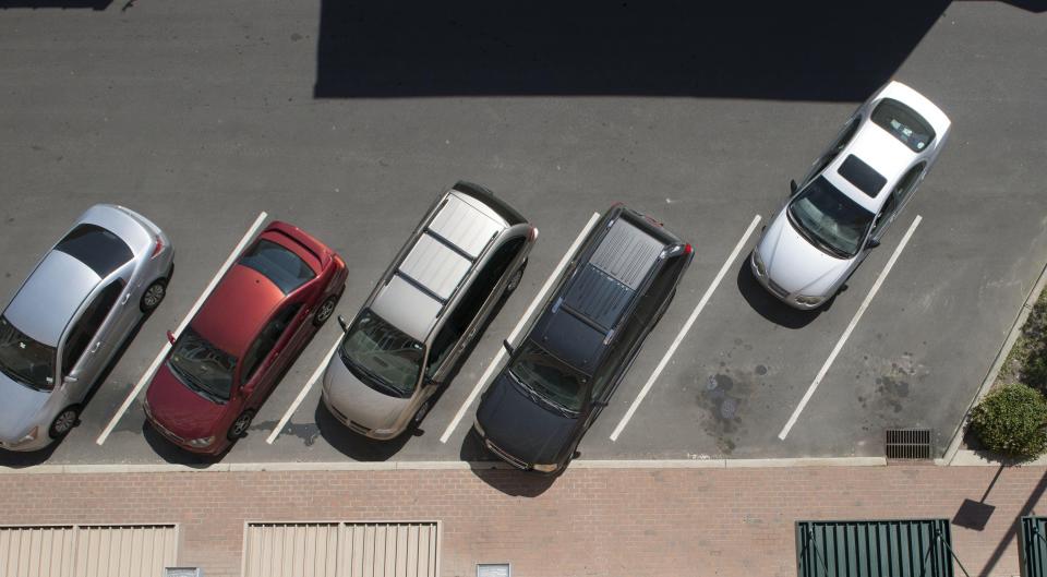 A car leaves a free parking space on Anderson Street in this view from the upper floor of the parking deck at Franklin and Anderson Street in downtown Fayetteville. The city of Fayetteville is now adding 52 new parking spaces to a parking lot between Winslow and Russel Streets.