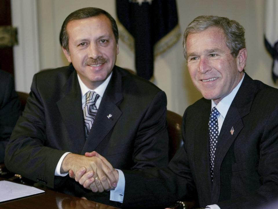 FILE - US President Bush, right, shakes hands with Recep Tayyip Erdogan, left, the leader of Turkey's ruling AK Party, as they participates in a meeting in the Roosevelt Room of the White House, on Dec. 10, 2002 in Washington. Erdogan, who is seeking a third term in office as president in elections in May, marks 20 years in office on Tuesday, March 14, 2023. (AP Photo/Pablo Martinez Monsivais, File)