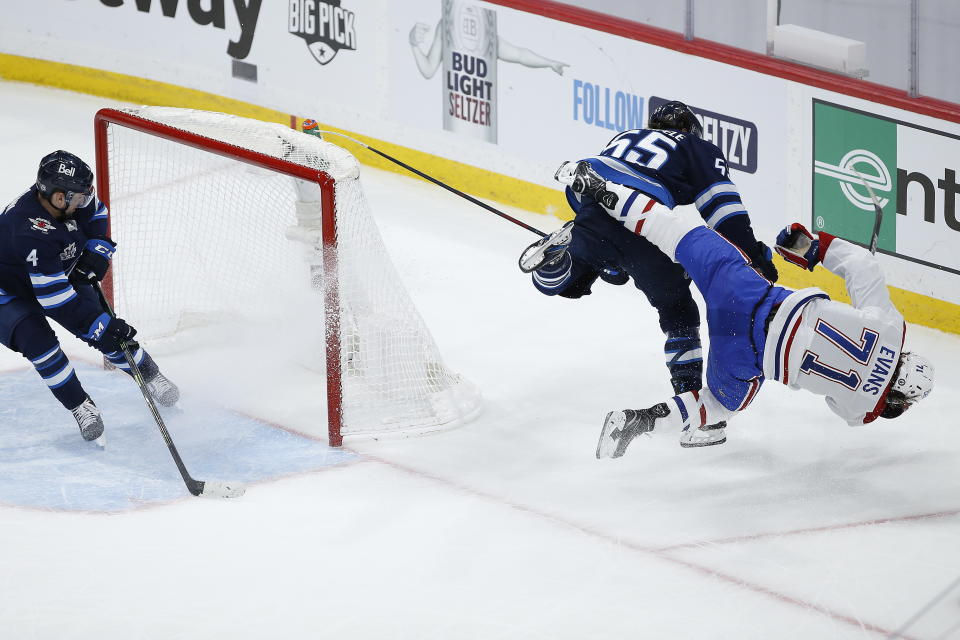 Winnipeg Jets' Mark Scheifele (55) hits Montreal Canadiens' Jake Evans (71) after Evans scored an empty-net goal during the third period of Game 1 of an NHL hockey Stanley Cup second-round playoff series Wednesday, June 2, 2021, in Winnipeg, Manitoba. (John Woods/The Canadian Press via AP)