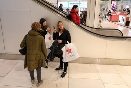 FILE PHOTO: People shop at Macy's Department store in New York