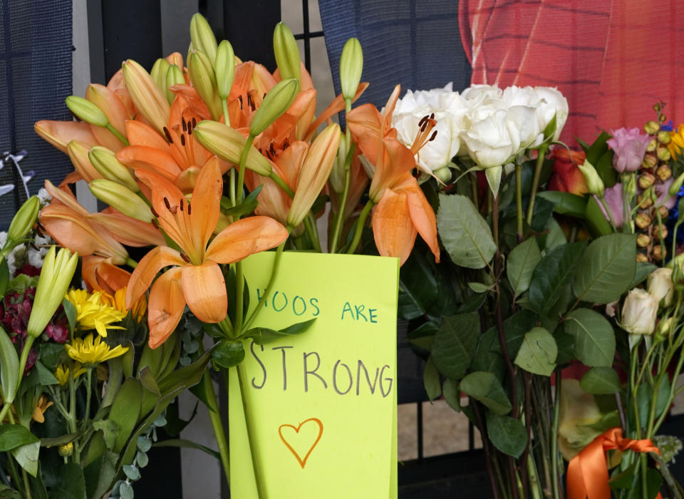 Memorial flowers and notes line walkway at Scott Stadium after three football players were killed in a shooting on the grounds of the University of Virginia Tuesday Nov. 15, 2022, in Charlottesville. Va. Authorities say three people have been killed and two others were wounded in a shooting at the University of Virginia and a student suspect is in custody. (AP Photo/Steve Helber)