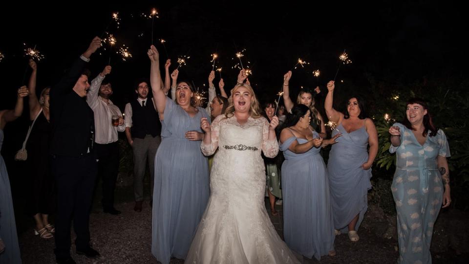 Kayley Stead and her bridesmaids and guests wave sparklers (Neil Jones Photography / SWNS)