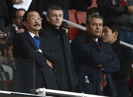 Cardiff City's owner Vincent Tan (L) and Ole Gunnar Solskjaer (C) are seen in the director's box before their English Premier League soccer match against Arsenal at the Emirates Stadium in London January 1, 2014. REUTERS/Dylan Martinez