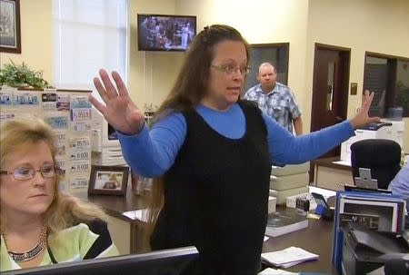 Rowan County Clerk Kim Davis gestures as she refuses to issue marriage licenses to a same-sex couple in Morehead, Kentucky September 1, 2015, in a still image from video provided by WLEX. REUTERS/WLEX/LEX18.com