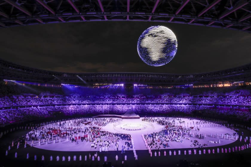 Tokyo, Japan, Friday, July 23, 2021 - Lighted drones take shape of a spinning earth at the Tokyo 2020 Olympics Opening Ceremony at Olympic Stadium. (Robert Gauthier/Los Angeles Times)