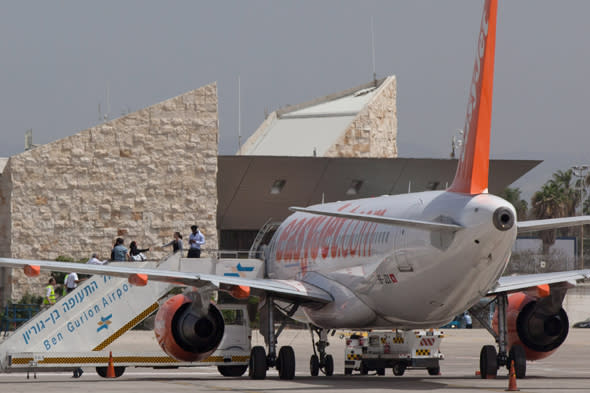 TEL AVIV, ISRAEL - APRIL 15:  (ISRAEL OUT) Passengers board a plane, which flew in Pro-Palestinian activists, before in heads back to Belgium on April 15, 2012 at the Ben Gurion Air Port near Tel Aviv, Israel. Some 650 policemen were stationed at the airport as hundreds of activists and protesters were due to arrive as part of the 