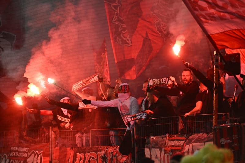 Bayer Leverkusen fans set off pyrotechnics during the German DFB Cup semi final soccer match between Bayer Leverkusen and Fortuna Duesseldorf at BayArena. Marius Becker/dpa