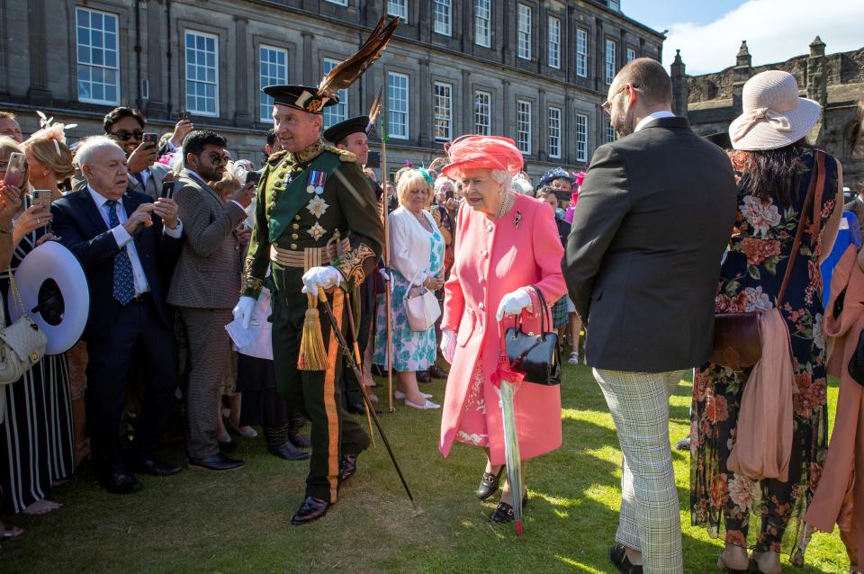 Britain's Queen Elizabeth II (C) attends a garden party at the Palace of Holyroodhouse in Edinburgh on July 3, 2019. (Photo by Jane Barlow / POOL / AFP)        (Photo credit should read JANE BARLOW/AFP via Getty Images)