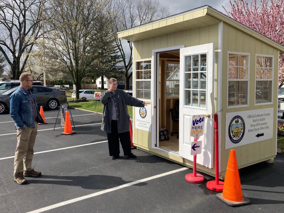 Lebanon County’s Bureau of Registration and Elections officials oversee a new mail-in ballot drop off point in front of the county municipal building for voters to submit their mail ballots.