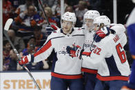 Washington Capitals' Nic Dowd (26) and Richard Panik (14) celebrate with teammate Carl Hagelin (62) after Hagelin scored a goal during the third period of an NHL hockey game against the New York Islanders Saturday, Jan. 18, 2020, in Uniondale, N.Y. The Capitals won 6-4. (AP Photo/Frank Franklin II)