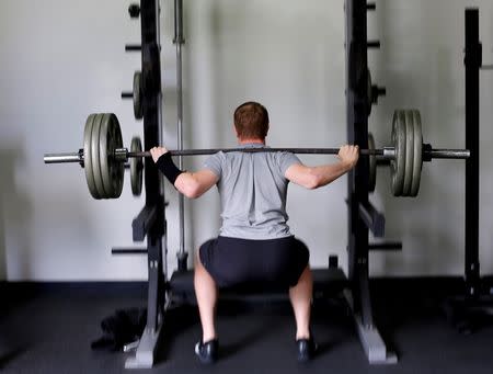 U.S. Olympic BMX athlete Connor Fields works out doing squats with a broken hand during a training session at a facility in Carlsbad, California, United States May 20, 2016. REUTERS/Mike Blake