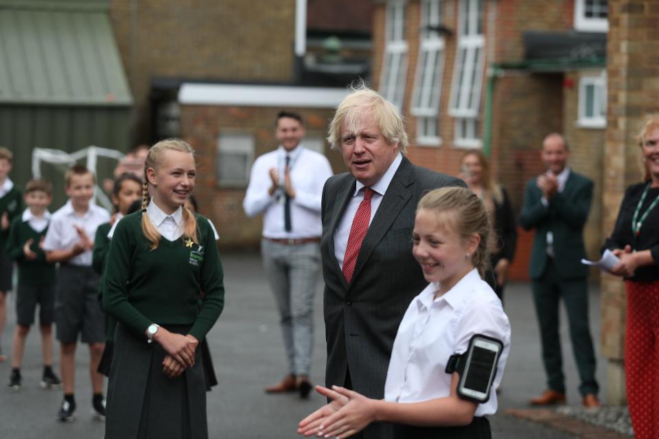 <p>Boris Johnson joins a socially distanced lesson during a visit to Bovingdon Primary School in Bovingdon, Hemel Hempstead, in June</p> (PA)