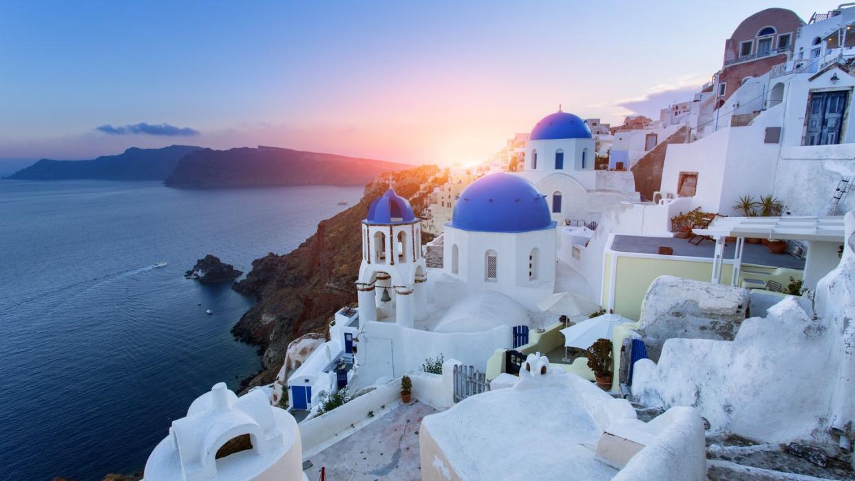 blue domed churches at sunset, oia, santorini