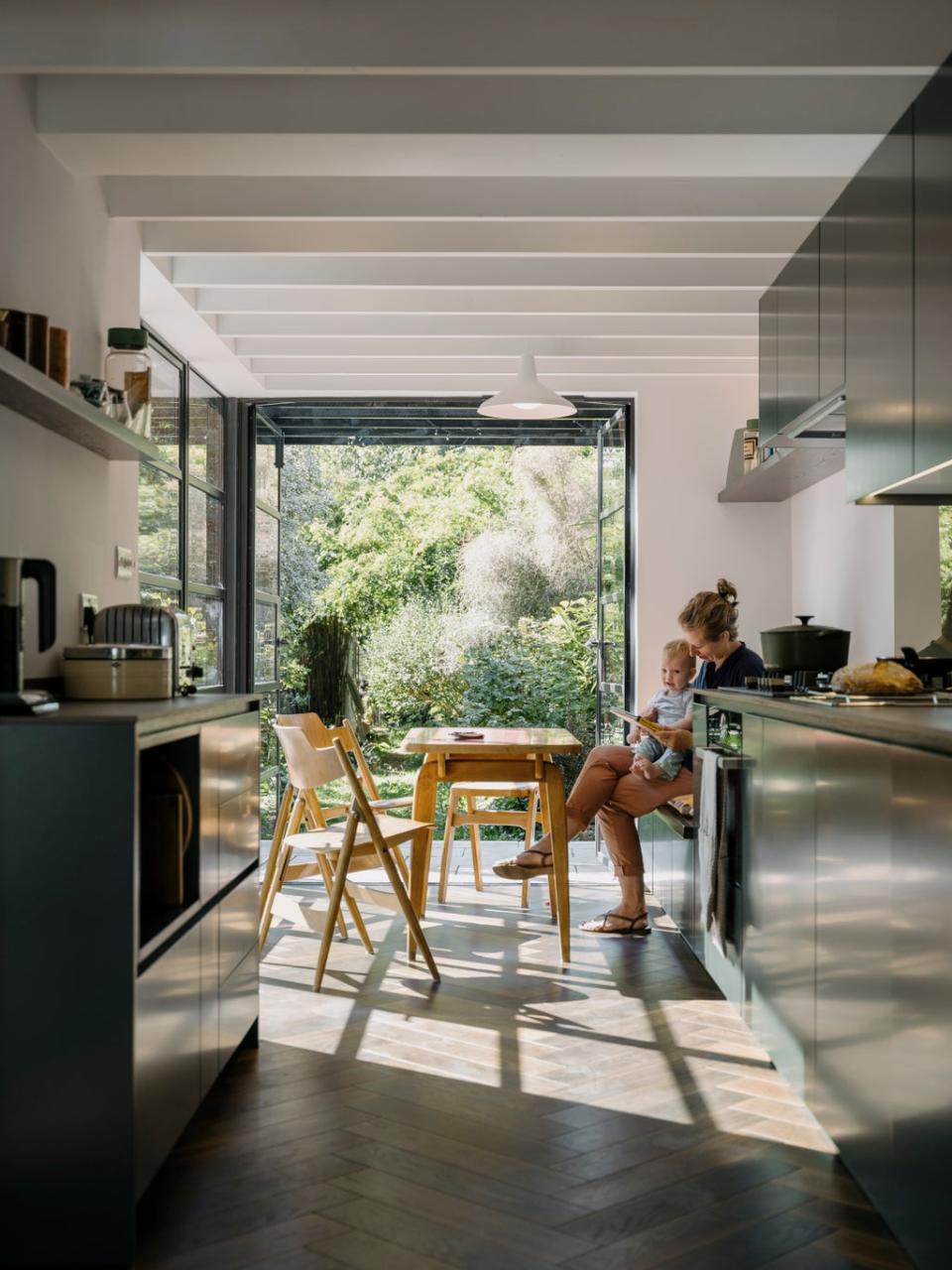 Architect Joanna Coleman admires her own handiwork in the light of the newly opened kitchen-diner (Tim Crocker)