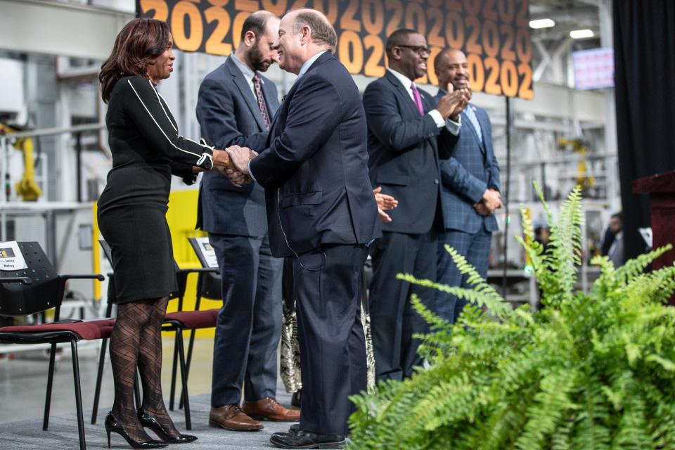 Mayor Mike Duggan shakes hands with City Clerk Janice Winfrey during the State of the City address at the Flex-N-Gate plant in Detroit on Feb. 25, 2020.