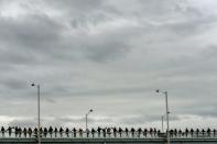 People hold hands to form a human chain protesting global warming during a gathering in Lyon, central-eastern France, on November 29, 2015