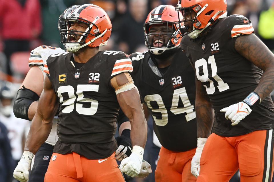 Cleveland Browns defensive end Myles Garrett (95) and defensive tackle Dalvin Tomlinson (94) and defensive end Alex Wright (91) celebrate after a tackle during the second half against the Chicago Bears at Cleveland Browns Stadium.