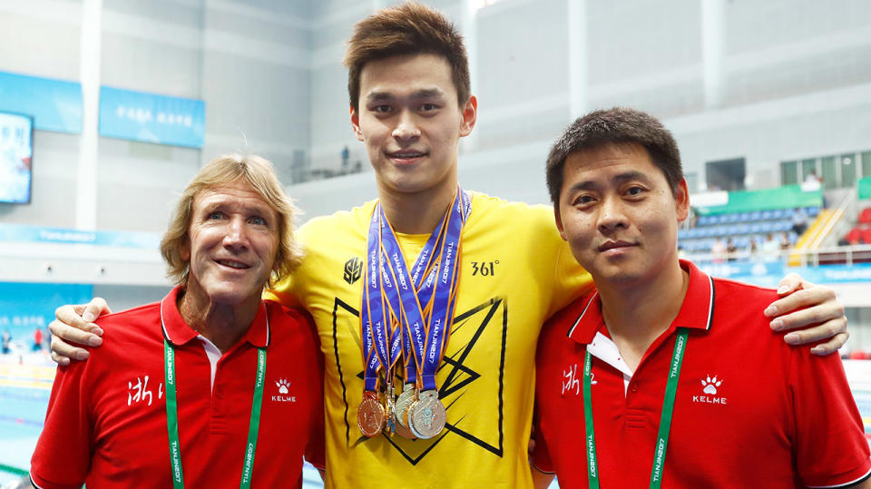 Australian coach Denis Cotterell (pictured left) smiles next to Sun yang (pictured middle) and Chinese coach Zheng Kunliang (pictured right).