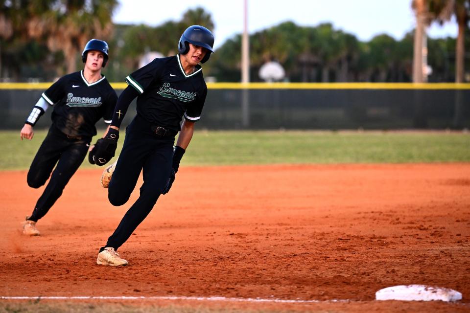 Suncoast's Aidan Arjune and Lee Ellis round third base on a big hit by Brady Benevides in the second inning of a regular season game against Treasure Coast on April 18, 2024.